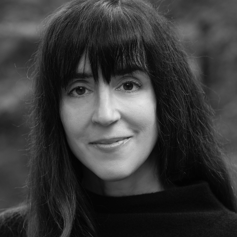 Black and white photograph of painter Hilary Harkness smiling